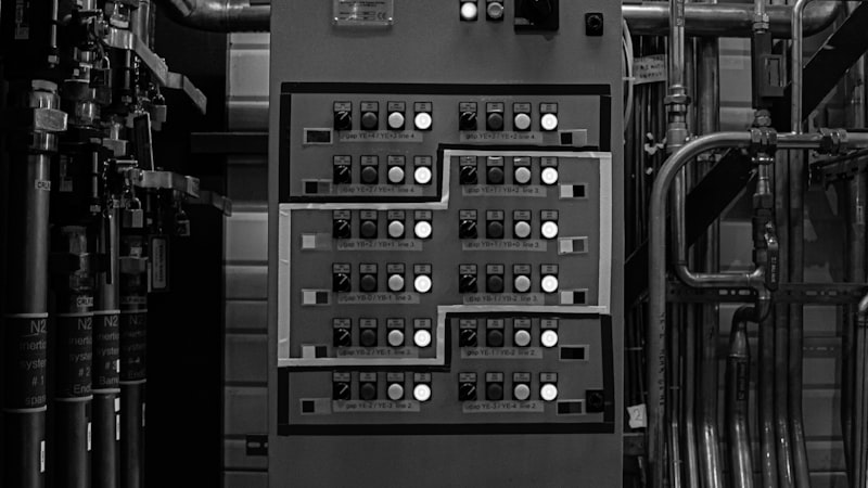 BMS control panel and building mechanical systems in a plant room
